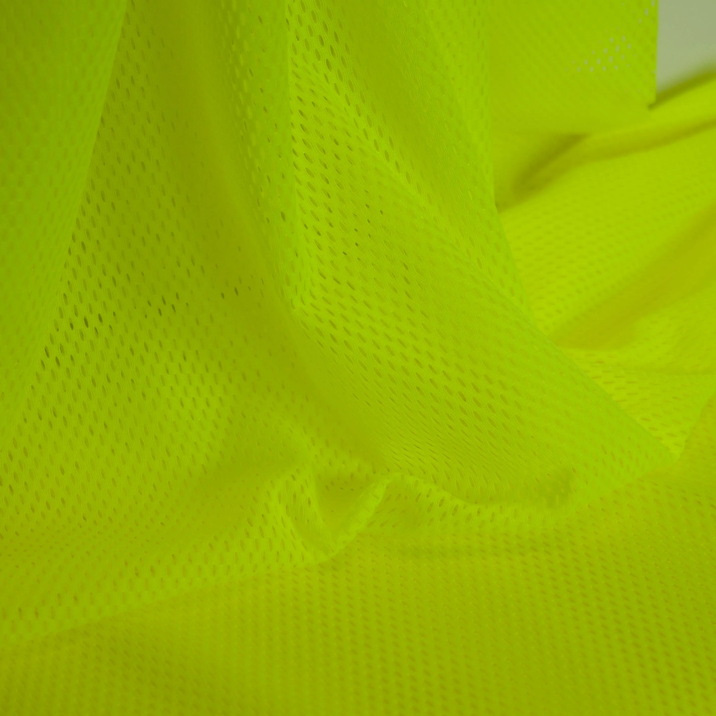polyester stretch met gaatjes fluo geel